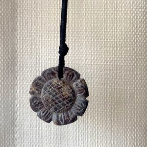 Natural stone necklace. Cord with carved stone in the shape of a flower